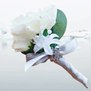 Image of pageboy mini buttonhole showing detail of carnation, silk baby's breath flower and silver satin bow.