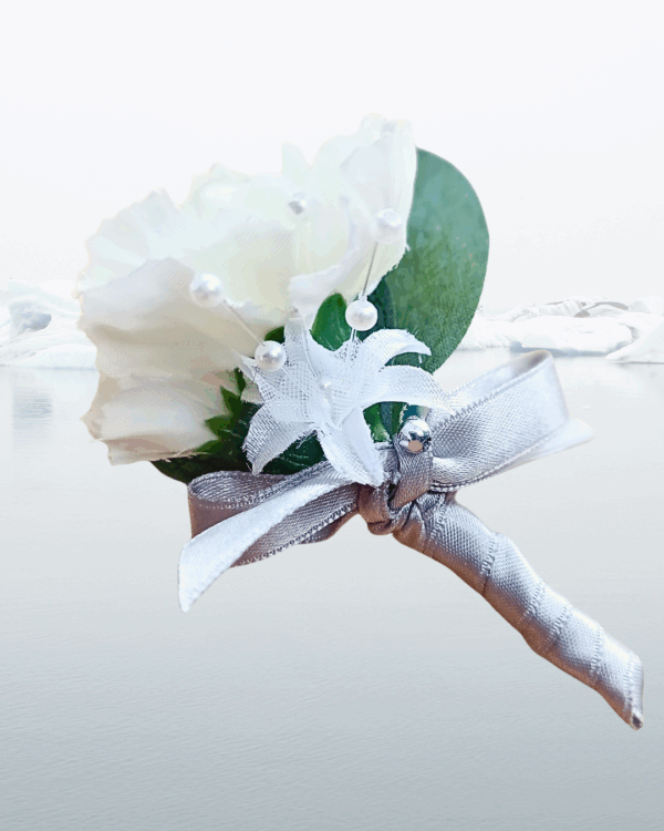 Image of pageboy mini buttonhole showing detail of carnation, silk baby's breath flower and silver satin bow.