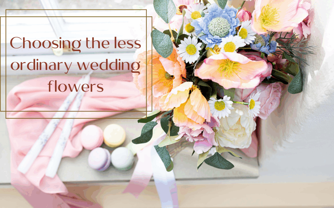 Image of silk flower bouquet in spring colours, with macarons, candles and peach fabric