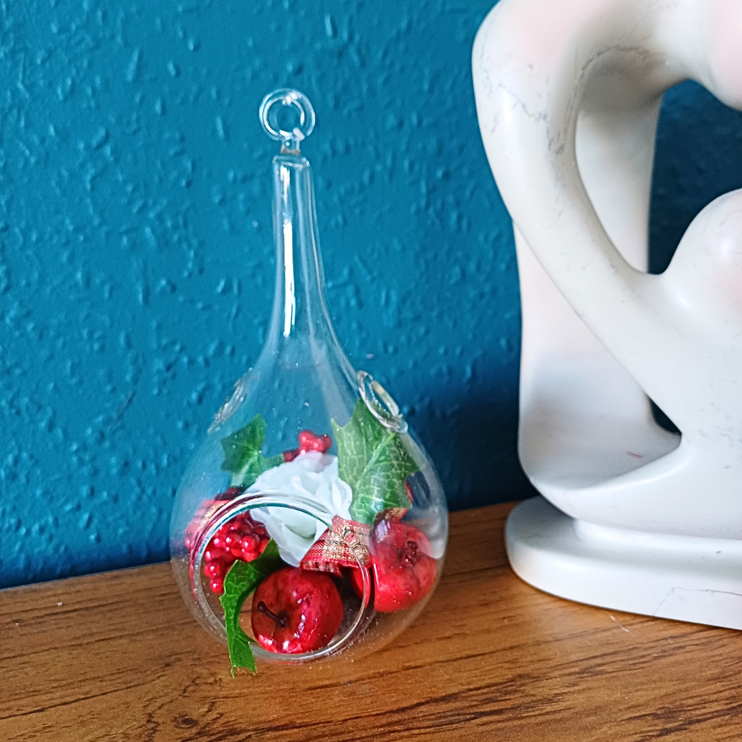 Glass teardrop festive ornament with faux red fruits and white silk rose and holly