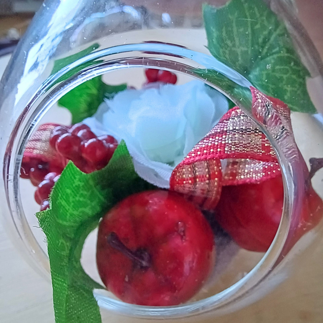 Glass teardrop festive ornament with faux red fruits and white silk rose and holly