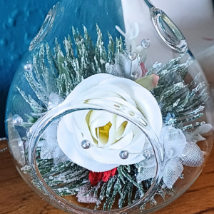 Glass teardrop festive ornament with white silk rose and silver faux pines foliage