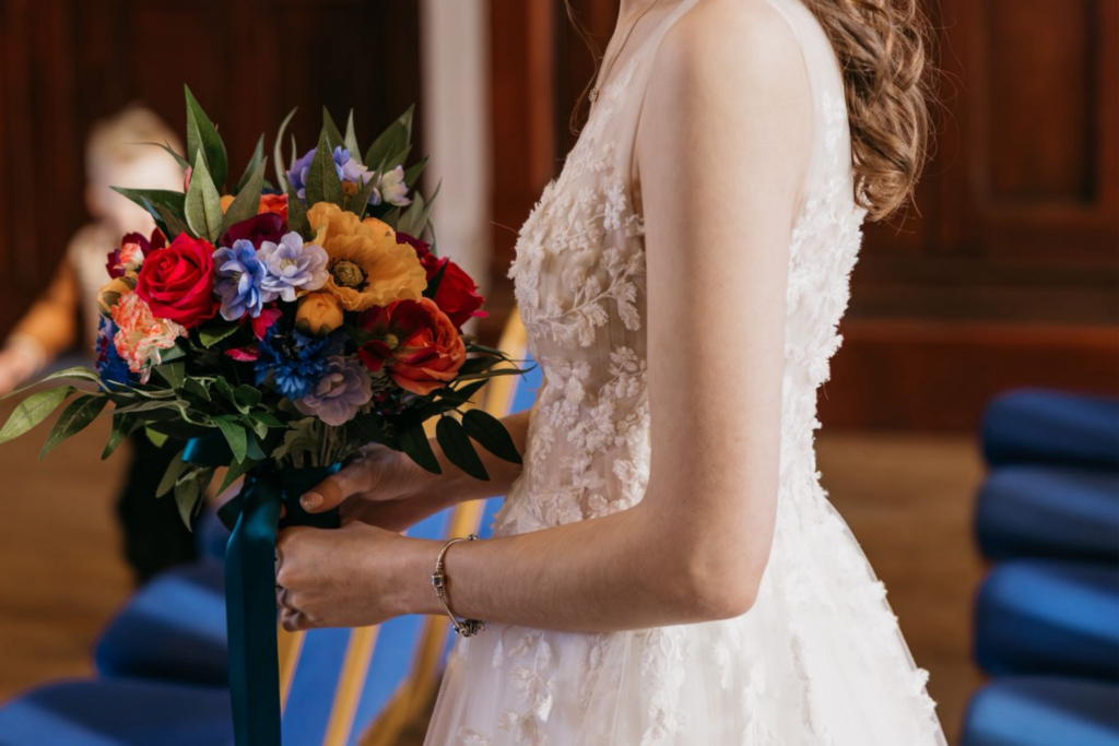 Image of bridal bouquet in bright colours of orange, pink, blue and purple