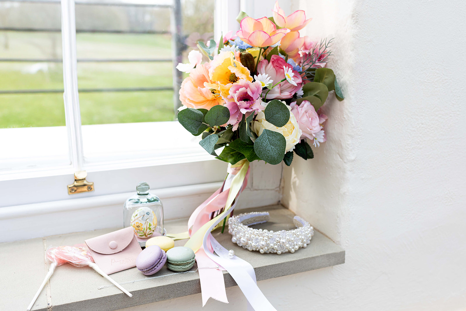 Image of spring flower bouquet, colours are pink, orange, blue and peach