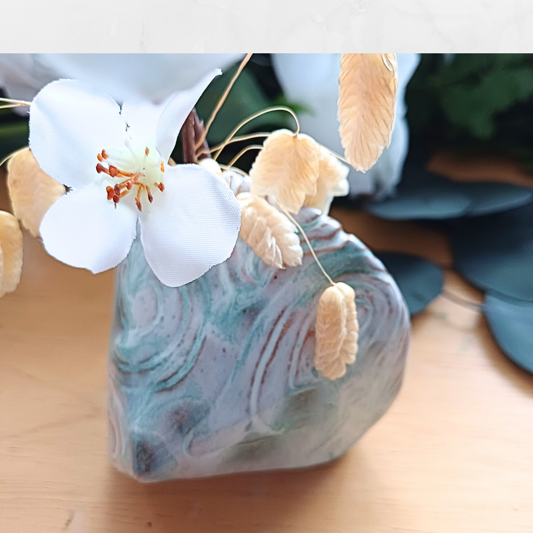 Image of triangular bud vase with swirly patterns, colours pale blue and turquoise