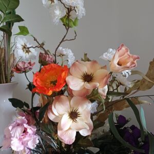 Mixed arrangement of silk flowers, red poppy, nude anemone, white apple blossom and pink cosmos