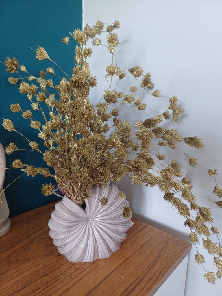 Vase with cascading dried gold weeping bamboo