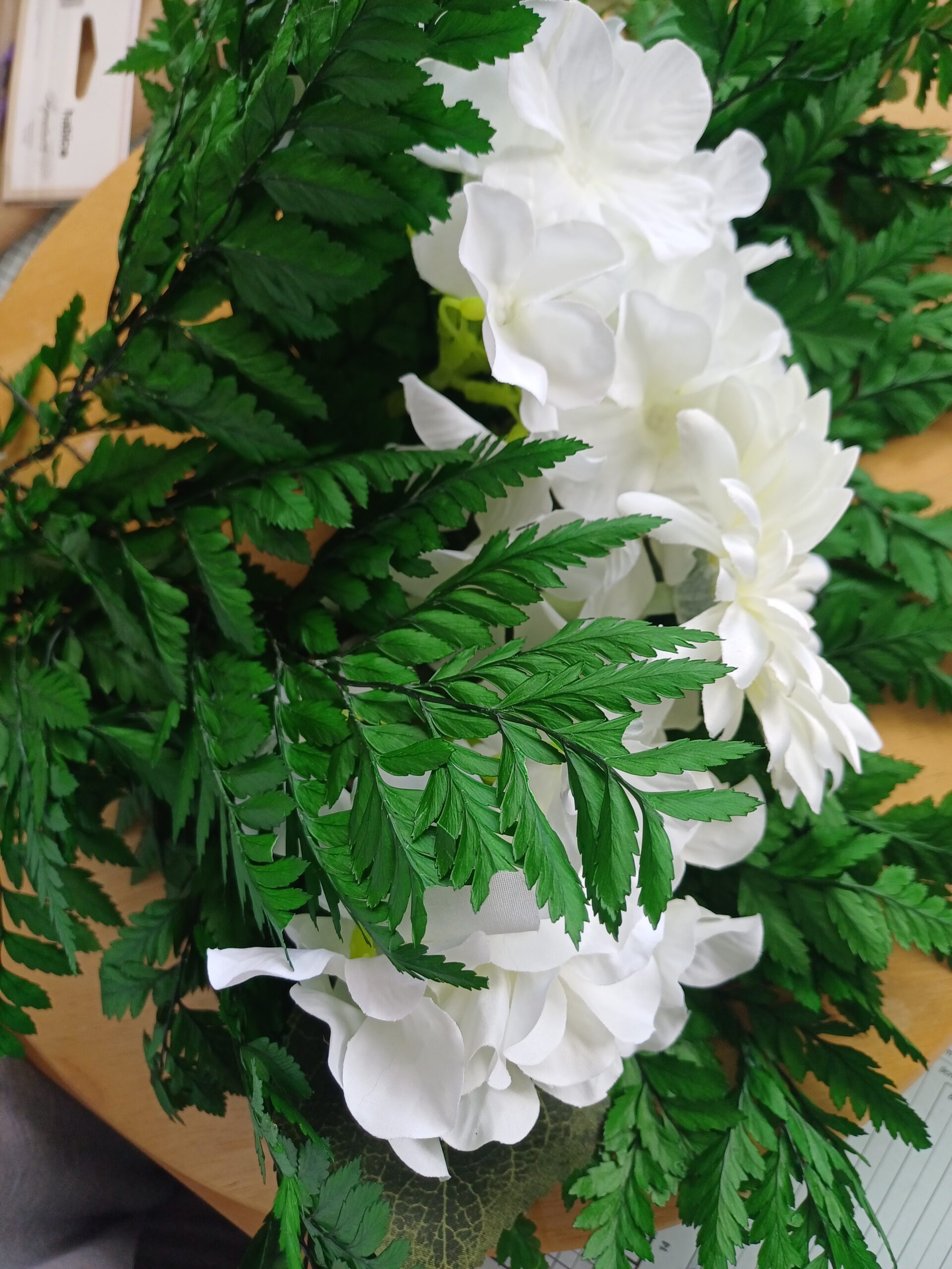 Emerald green preserved leatherleaf fern with white flowers